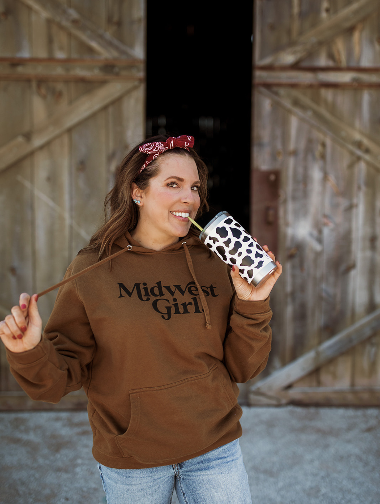 Annaliese in Midwest Girl sweatshirt and drinking from cow cup