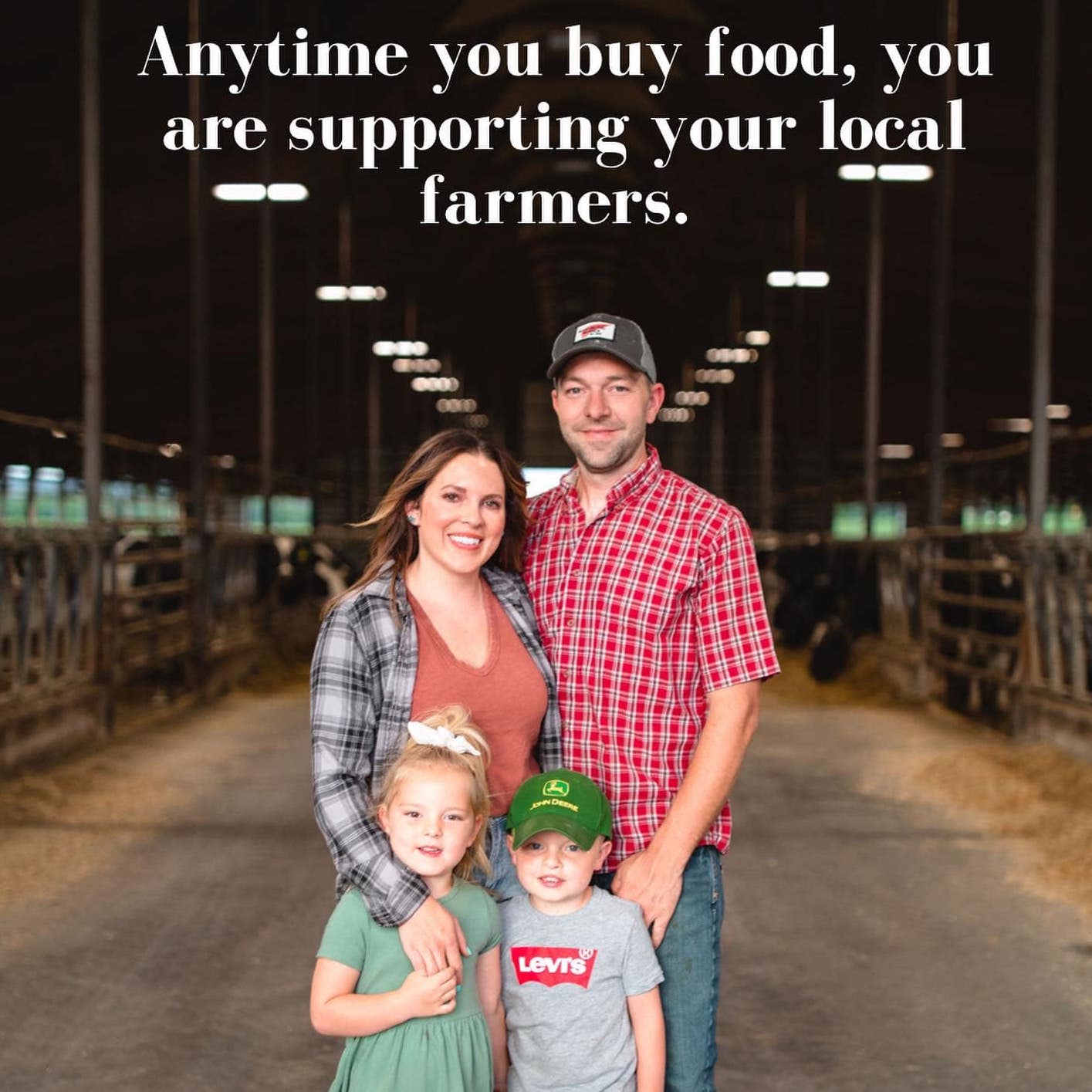 Wisconsin dairy farm family in a freestall barn - anytime you buy food, you are supporting your local farmers.