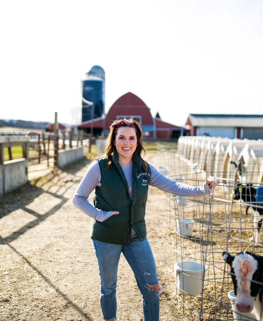 Annaliese Wegner - Modern Day Farm Chick - Wisconsin Dairy Farmer standing in front of calf hutches