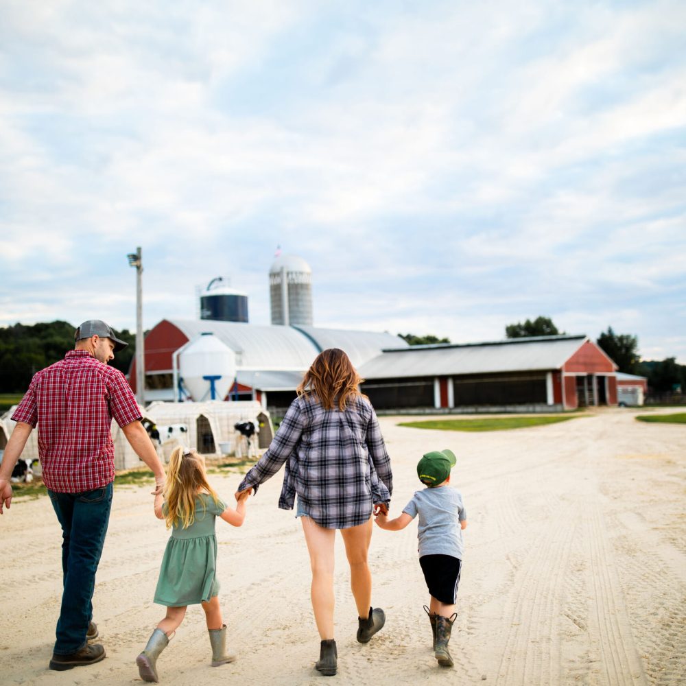 Wisconsin dairy farm family walking on their farm
